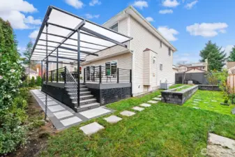Raised vegetable bed and 5 varieties of fruit trees make this back yard a gardener's dream.