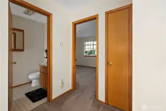 Hallway to 2nd Bathroom, Linen Closet, and Primary bedroom.