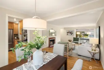 Looking in from the Dining Room, expansive Living Room with centerpiece fireplace and great eastern, southern and western natural light.