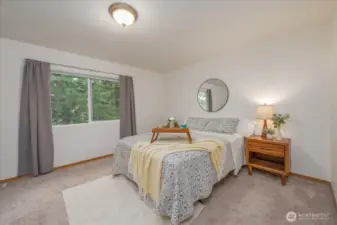 Main bedroom is filled with warm light and so spacious.  Trees provide privacy and nature garden.
