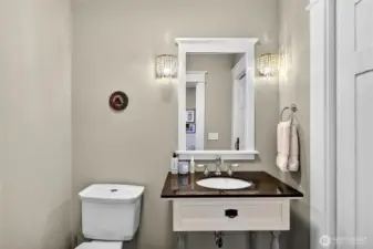 Main level powder room with closet for additional storage.
