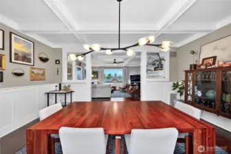 Dining room with picture frame molding and box and beam ceiling details.