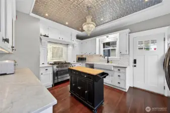 Pressed tin ceiling and cove accent details with a fun chandelier.
