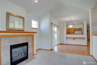 Living room has vaulted ceilings and cozy gas fireplace.