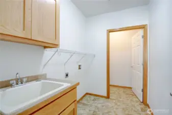Laundry room with broom closet is centrally located near kitchen, 3rd bed/den and garage.