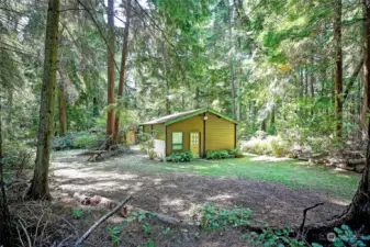 From cleared space looking to cabin. RV dump by cabin.