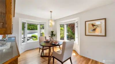 Breakfast nook with bay windows out to the lush landscaping.