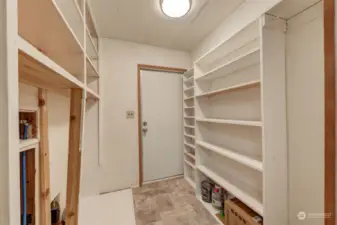 Large utility room with washer and dryer hookups, leading out to the back porch access.