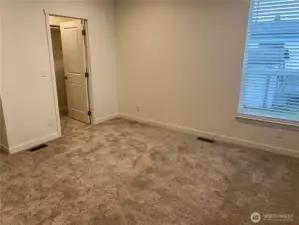 Primary bedroom looking at walk in closet.