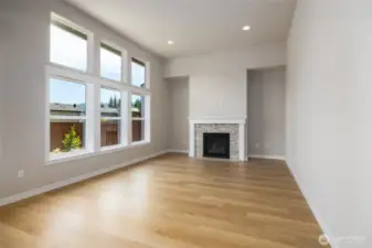 The great room has lots of glass and a gas fireplace.