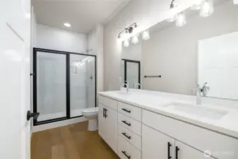 There is a tile shower and double sinks with a taller toilet in the primary bathroom.  Lots of counter space!