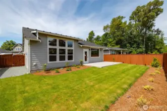 The backyard is landscaped and fenced.