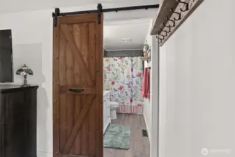 Primary bathroom with charming barn door.