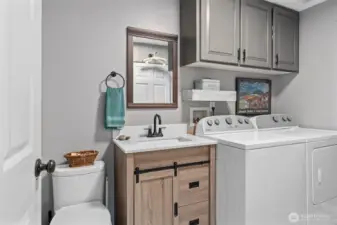 Lower-level half bath/utility room with large closet/pantry!