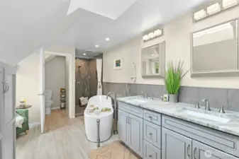 Spa-like updated primary bath with walk-in closet and extra storage.