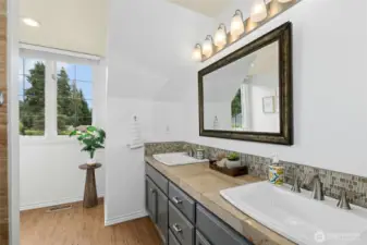Oversized shared hall bath with dual sinks.