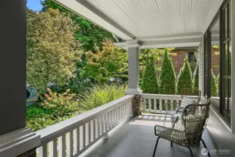 Covered front porch is calling for your relaxing cup of coffee.