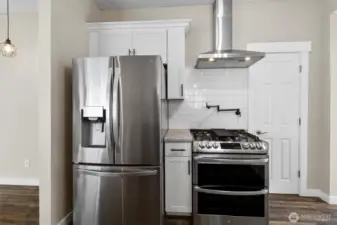 Near-new appliances, including double oven and pot filler above stove.