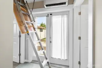 Attic access with pull-down ladder. Double doors to the back yard. 3/4 bathroom on right, 3rd bedroom on left. Attic access had small room containing the on demand water heater and partially finished with storage shelving. There is a door up there that leads to the attic space that spans across the house and includes an exhaust fan that runs on a thermostat to keep the house cool in the summer.