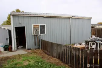 Shop with man door and sliding door on right for car entrance.