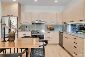 Beautiful custom cabinets along with detailed tile work, black matte sink fixtures, and warm quartz counters complete an inspiring and inviting space for creating.