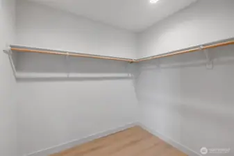Large walk-in closet offering an opportunity for built-in organization & generous storage.