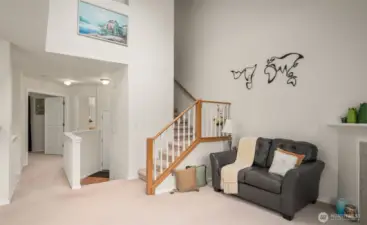 Living room with high ceiling. New carpet is grey color