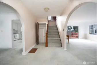 Welcome.  To the right is the large living room, to the left is the dining room and kitchen, to the left of the staircase is a half bath and the stairs to the unfinished basement.