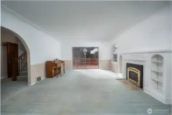 The living room is ginormous and is complete with a gas fireplace flanked by built-ins.  Access to the large deck and back yard make for easy indoor/outdoor living and lifestyle.