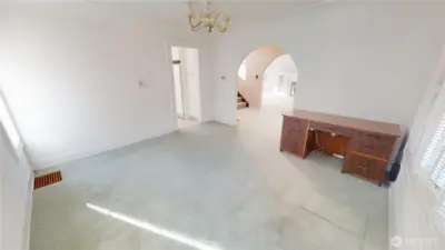 Another view of the dining room.  There are hardwood floors under the carpets- pull up the carpets and refinish the floors- make this home shine again.