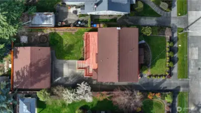 An aerial shot shows the fun landscaping and placement of the home on its lot.  And?  The roofs still have lots of life left, having been replaced approximately 10 years ago.