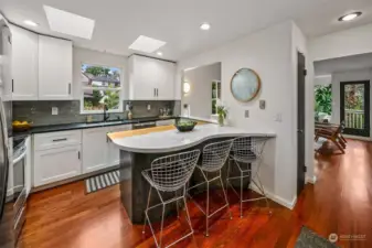 Open concept kitchen with French marble peninsula and bar seating