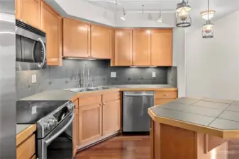 Island kitchen with newer Stainless Steel appliances.