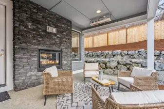 Covered rear patio with fireplace, heat lamps, and ready for your TV. Perfect space for enjoying your morning coffee, relaxing after work, or entertaining.