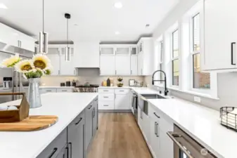JennAir Rise appliances, deep farmhouse sink, and touchless faucet.