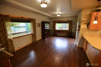 The spacious dining room with coffered ceiling, natural light, and creates a wonderful hub to this country home.