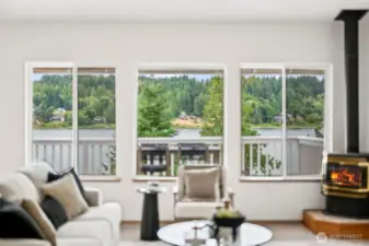 Large picture windows frame tranquil water and wooded views