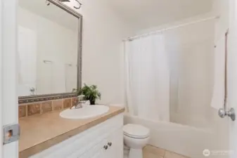 Full main bathroom with a tub