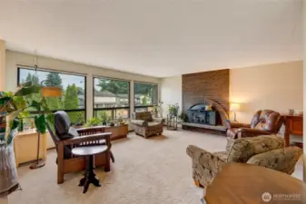 Upstairs living area featuring wooden fireplace.