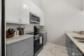 remodeled kitchen with quartz countertops and tile flooring-cabinets are soft close and appliances are all new as well