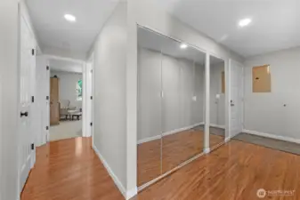 entrance hallway and hallway to bedrooms-washer and dryer are located behind the glass closet doors