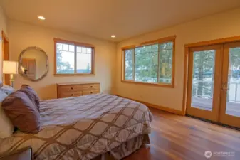 Primary suite opens to deck with bay waterfront views