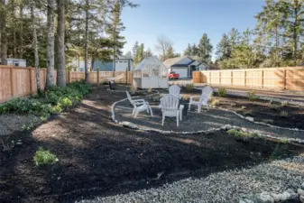 Stunning outdoor spaces to enjoy. Low maintenance landscaping, firepit area, green house and hammock