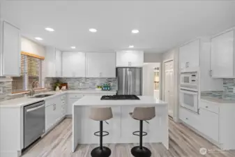 This kitchen will motivate you to cook and entertain with a large island featuring quartz waterfall counters, newer gas range, newer dishwasher and brand new refrigerator