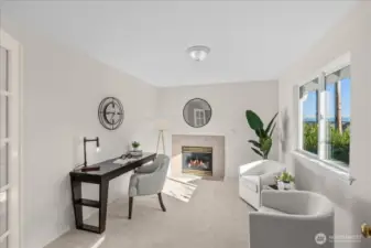 This is the sitting room off the primary bedroom - featuring double doors and a gas fireplace