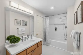 Upstairs Guest Bathroom - Recently remodeled with new quartz counters, new flooring, lighting and new tile shower. Enjoy all the extra storage in the linen closet too.