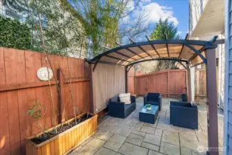 The pergola provides 3 season comfort and the outdoor furniture will remain for the buyer