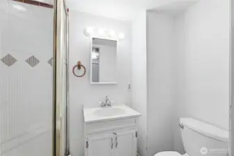 Primary ensuite featuring a 3/4 bath layout (shower, no tub). This space-efficient design is ready for a quick cosmetic refresh to create a modern, high-end primary retreat.