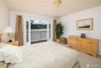 Bedroom with private balcony and spacious closet.