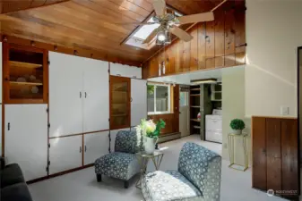 This photo is looking at the back of the den towards the laundry area.  Attic access is through the hidden door in the overhead wood paneling in the center of the picture.  The electric furnace is located in the attic.